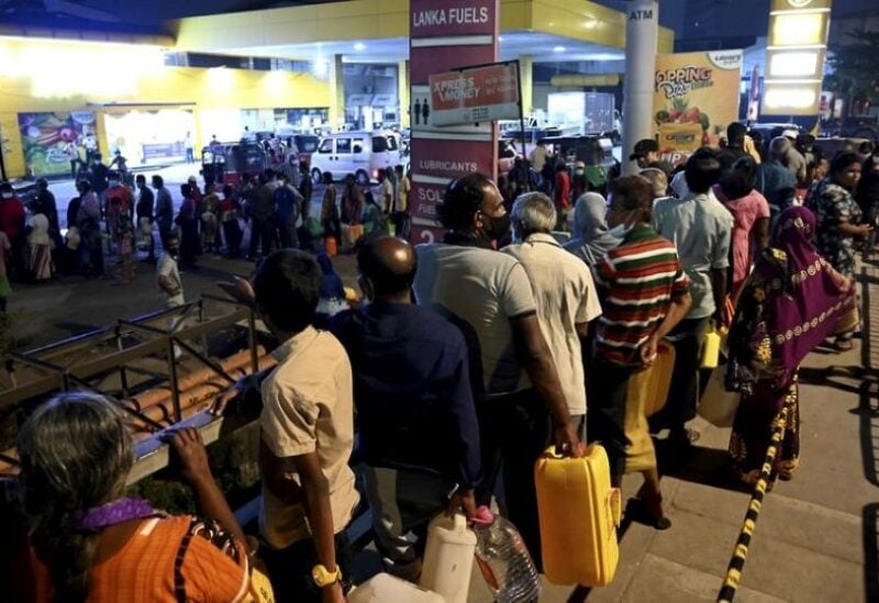 People queue to buy oil for home use at a petrol station in Colombo, Sri Lanka,
