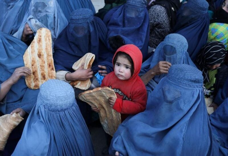 People reach out to receive bread, in Kabul, Afghanistan,
