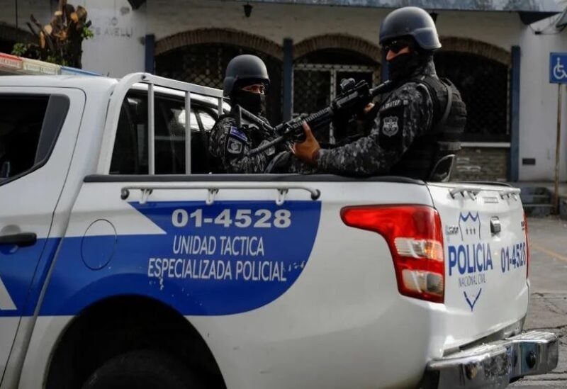 Police officers secure a convoy where suspected gang members are transported after being arrested on charges of being linked to last week's spike in homicides, in San Salvador,