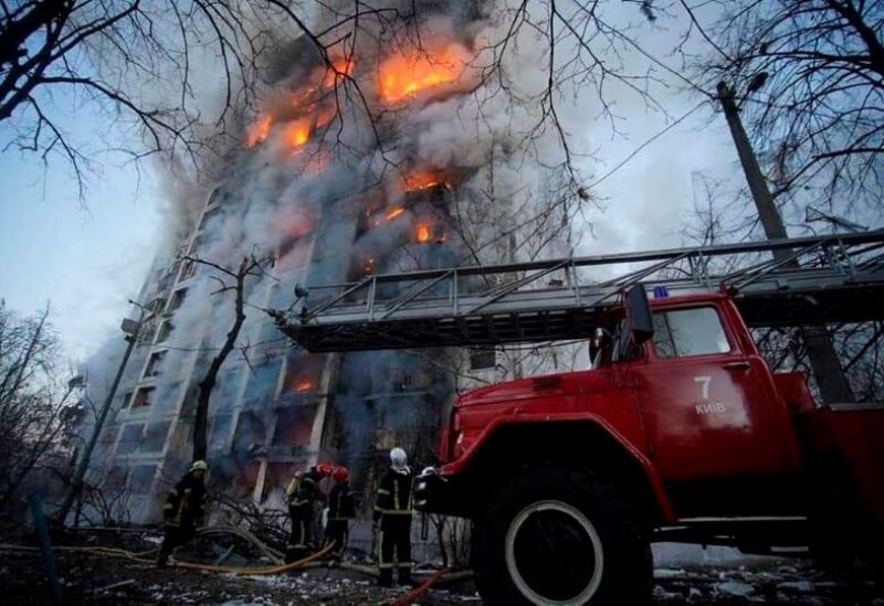 Rescuers work next to a residential building damaged by shelling, as Russia's attack on Ukraine continues, in Kyiv, Ukraine,