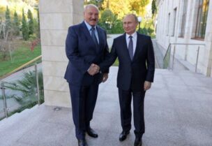 Russia's President Vladimir Putin (L) shakes hands with his Belarus’ counterpart Alexander Lukashenko