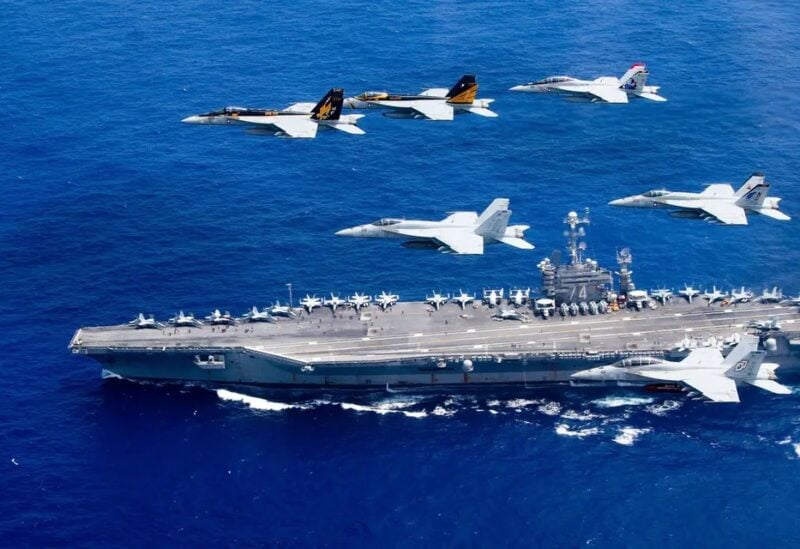 A combined formation of aircraft from Carrier Air Wing (CVW) 5 and Carrier Air Wing (CVW) 9 pass in formation above the Nimitz-class aircraft carrier USS John C. Stennis