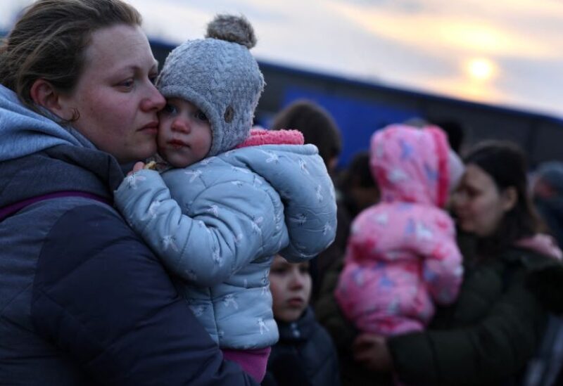 Ukrainian family members hug each other, after fleeing the Russian invasion of the