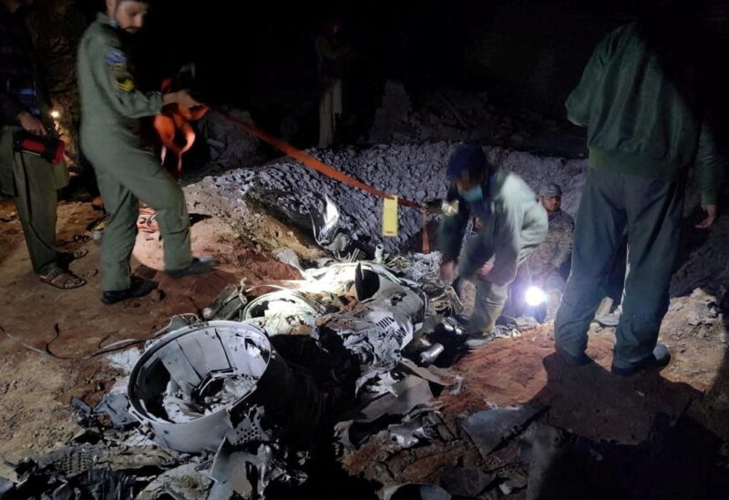 People work around what Pakistani security sources say is the remains of a missile fired into Pakistan from India, near Mian Channu, Pakistan, March 9, 2022. Picture taken March 9, 2022. Pakistani security