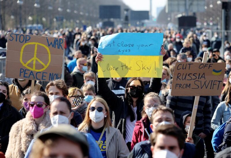 People hold signs at the anti-war concert