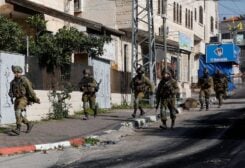 Israeli soldiers run during a raid in Jenin in the Israeli-occupied West Bank March 30, 2022.