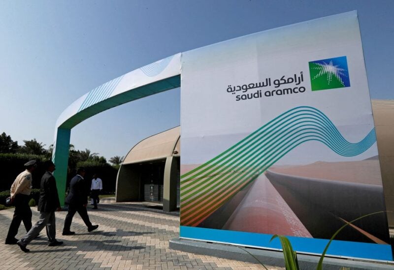 The logo of Aramco is seen as security personnel walk before the start of a press conference by Aramco at the Plaza Conference Center in Dhahran, Saudi Arabia November 3, 2019. REUTERS/Hamad I Mohammed