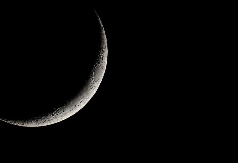 A waxing crescent moon rises over the town of Elefsina, Greece, June 13, 2021. (Reuters)