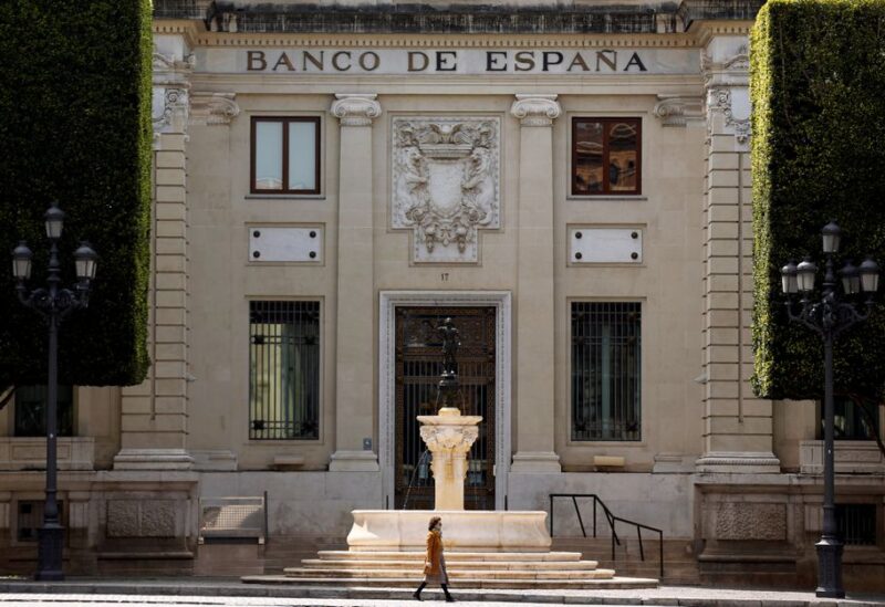 A woman walks past a Bank of Spain branch, during the coronavirus disease (COVID-19) outbreak, in the Andalusian capital of Seville, Spain, April 10, 2020. REUTERS/Marcelo del Pozo