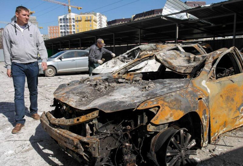 Men inspect destroyed cars in the aftermath of a military strike on a building, amid Russia's invasion, in Odesa, Ukraine, April 24, 2022. REUTERS/Igor Tkachenko