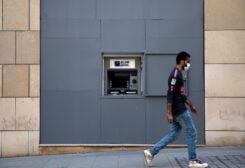 FILE PHOTO: A man wearing a face mask walks past a fortified Blom Bank ATM machine, as Lebanon imposed a partial lockdown for two weeks starting on Friday in an effort to counter the spread of the coronavirus disease (COVID-19), in Beirut, Lebanon August 21, 2020. REUTERS/Alkis Konstantinidis//File Photo