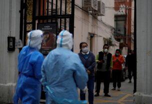 Residents line up for nucleic acid tests during a lockdown, amid the coronavirus disease (COVID-19) pandemic, in Shanghai, China, April 16, 2022. REUTERS