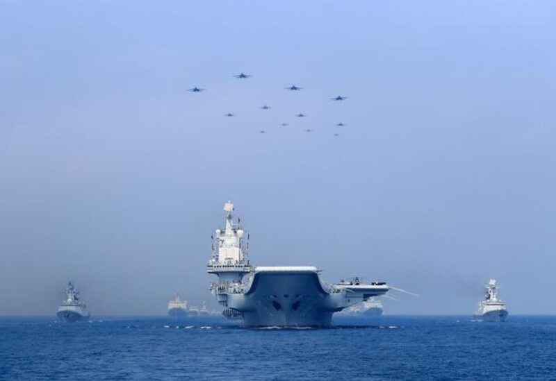 FILE PHOTO - Warships and fighter jets of the Chinese People's Liberation Army (PLA) Navy take part in a military display in the South China Sea April 12, 2018. REUTERS/Stringer/File Photo