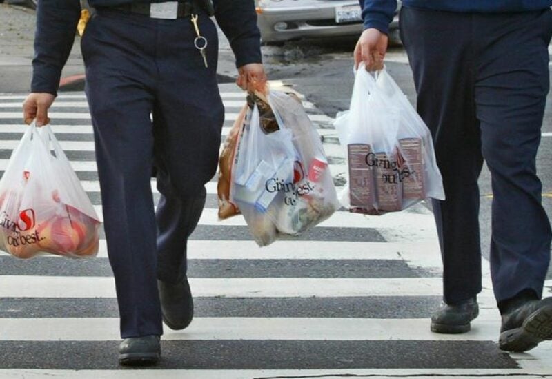 Firemen carry plastic grocery bags as they return to their station in San Francisco, California, in this file photo taken January 26, 2005. REUTERS/Kimberly White