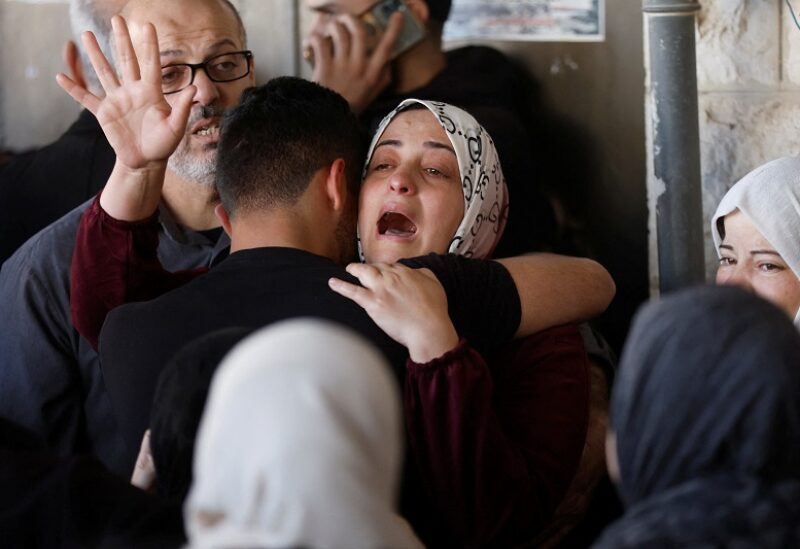 A relative reacts after Israeli forces killed Palestinian Mohammed Assaf during clashes in a raid, according to medics, in Nablus, in the Israeli-occupied West Bank, April 13, 2022. REUTERS/Mohamad Torokman