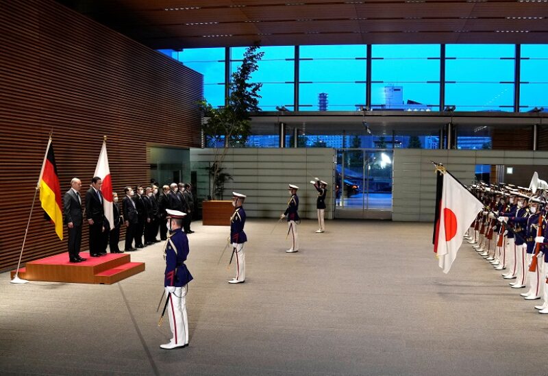 German Chancellor Olaf Scholz and his Japanese counterpart Fumio Kishida view an honor guard ahead of their bilateral meeting at the Prime Minister's Office in Tokyo, Japan, April 28, 2022. Shuji Kajiyama/Pool via REUTERS