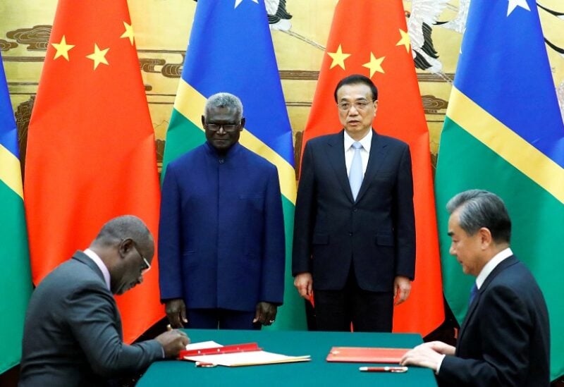 FILE PHOTO: (L-R) Solomon Islands Prime Minister Manasseh Sogavare, Solomon Islands Foreign Minister Jeremiah Manele, Chinese Premier Li Keqiang and Chinese State Councillor and Foreign Minister Wang Yi attend a signing ceremony at the Great Hall of the People in Beijing, China October 9, 2019. REUTERS/Thomas Peter/File Photo