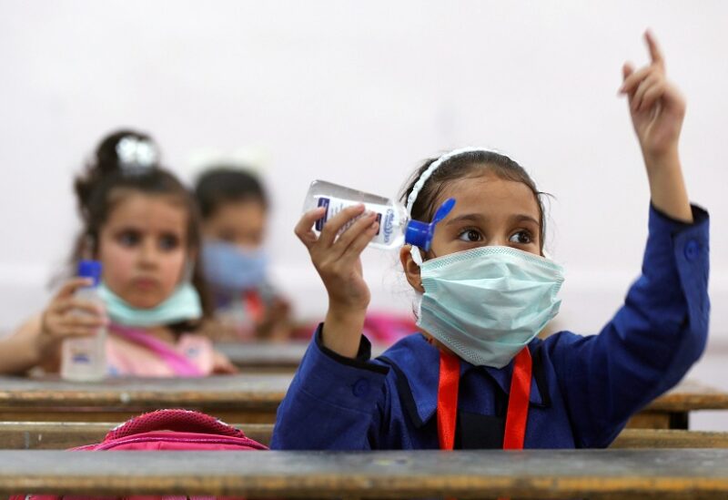 Refugee students learn how to sanitise their hands on the first day of the new school year at one of the UNRWA schools, amid fears of rising numbers of the coronavirus disease (COVID-19) cases in Amman, Jordan September 1, 2020. REUTERS/Muhammad Hamed - RC2OPI9NGIE0