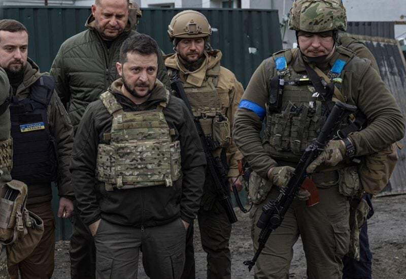 Ukraine's President Volodymyr Zelenskiy looks on as he is surrounded by Ukrainian servicemen as Russia's invasion of Ukraine continues, in Bucha, outside Kyiv, Ukraine, April 4, 2022. REUTERS/Marko Djurica