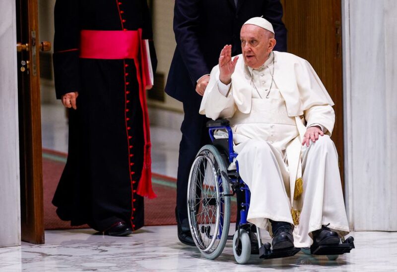 Pope Francis arrives on a wheelchair to meet with participants in the plenary assembly of the International Union of Superiors General (IUSG) at the Vatican, May 5, 2022. REUTERS/Guglielmo Mangiapane