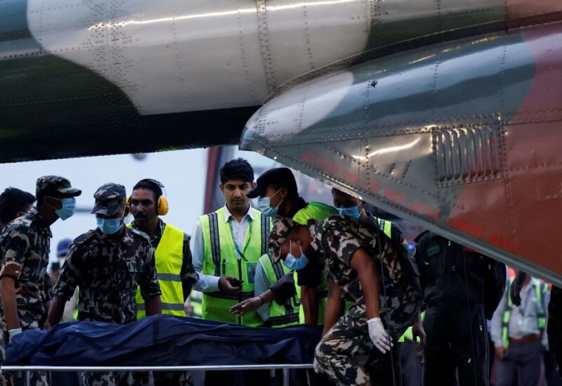 Member of Nepal Army carries the body of a victim of the Tara Air passenger plane, that crashed with 22 people on board while on its way to Jomsom, from the helicopter at the airport in Kathmandu, Nepal May 30, 2022. REUTERS/Navesh Chitrakar