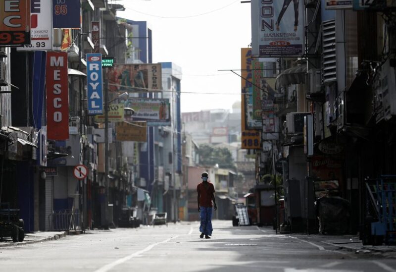 A man walks along a deserted road in Colombo, Sri Lanka, May 11, 2022. REUTERS/Dinuka Liyanawatte