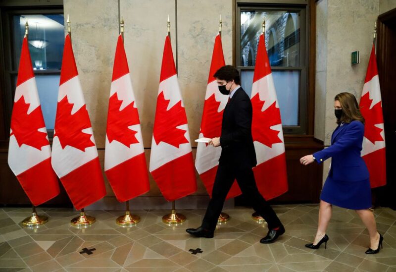 Canada's Prime Minister Justin Trudeau and Finance Minister Chrystia Freeland arrive before posing for a picture holding the 2022-23 budget, on Parliament Hill in Ottawa, Ontario, Canada, April 7, 2022. REUTERS/Patrick Doyle