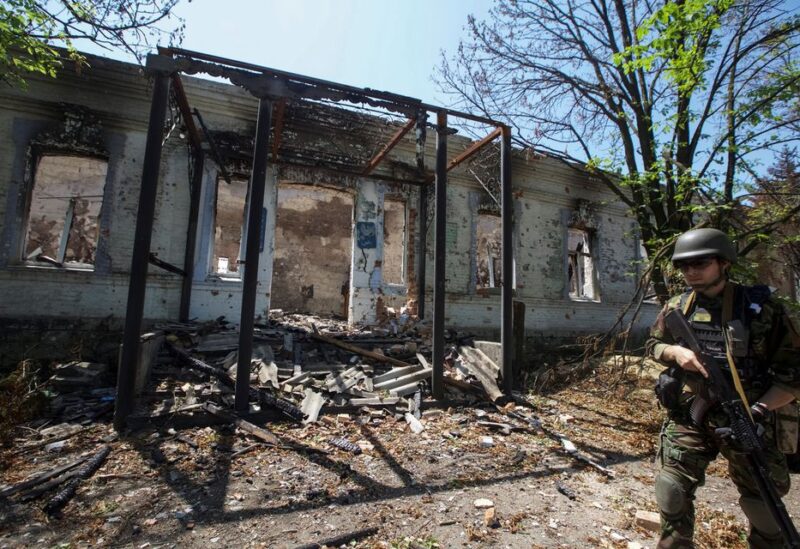 A police officer checks an area during an evacuation of local residents between shelling, amid Russia's attack on Ukraine, in the village of Novomykhailivka, in Donetsk region, Ukraine May 29, 2022. Picture taken May 29, 2022. REUTERS/Anna Kudriavtseva