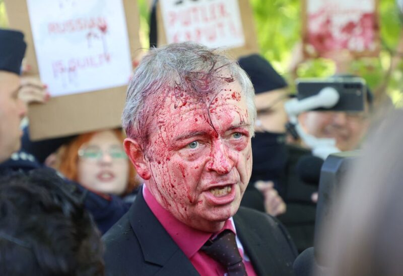 Russia's ambassador to Poland Sergey Andreev is covered in red substance thrown by protesters as he came to celebrate Victory day at the Soviet Military Cemetery to mark the 77th anniversary of the victory over Nazi Germany, in Warsaw, Poland May 9, 2022. Slawomir Kaminski/Agencja Wyborcza.pl via REUTERS