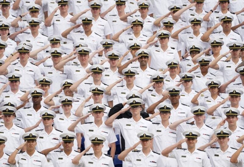 Underclass midshipmen salute during the national anthem at the U.S. Naval Academy graduation and commissioning ceremony in Annapolis, Maryland, U.S., May 27, 2022. REUTERS/Kevin Lamarque
