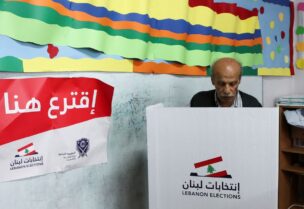 A man casts his vote at a polling station, during the parliamentary election, in Beirut, Lebanon May 15, 2022.