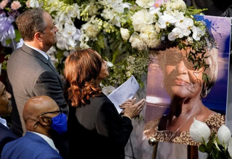U.S. Vice President Kamala Harris and her husband Douglas Emhoff stand next to a portrait of Ruth Whitfield, an 86-year-old victim of the recent mass shooting in Buffalo, as they attend the funeral service for her at Mount Olive Baptist Church in Buffalo, New York, U.S., May 28, 2022. REUTERS/Kevin Lamarqu