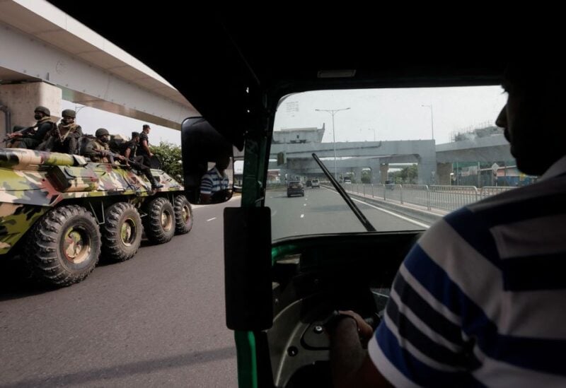 Army members travel on an armoured car on the main road after the curfew was extended for another extra day - REUTERS