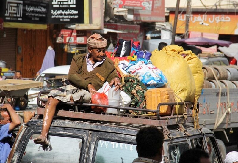 A man rides on top of a taxi car while leaving the city of Taiz, Yemen May 15, 2022. Picture taken May 15, 2022. REUTERS/Anees Mahyoub