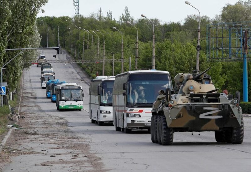 Buses carrying service members of Ukrainian forces who have surrendered after weeks holed up at Azovstal steel works drive away under escort of the pro-Russian military in the course of Ukraine-Russia conflict in Mariupol, Ukraine May 17, 2022. REUTERS/Alexander Ermochenko