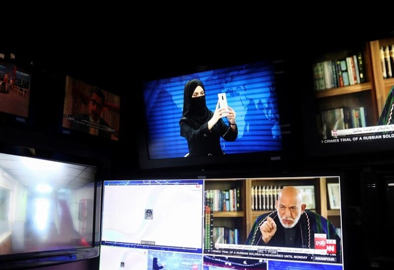 A female presenter for Tolo News, Khatereh Ahmadi takes a selfie in a newsroom while her face is covered at Tolo TV station in Kabul, Afghanistan, May 22, 2022. REUTERS/Ali Khara