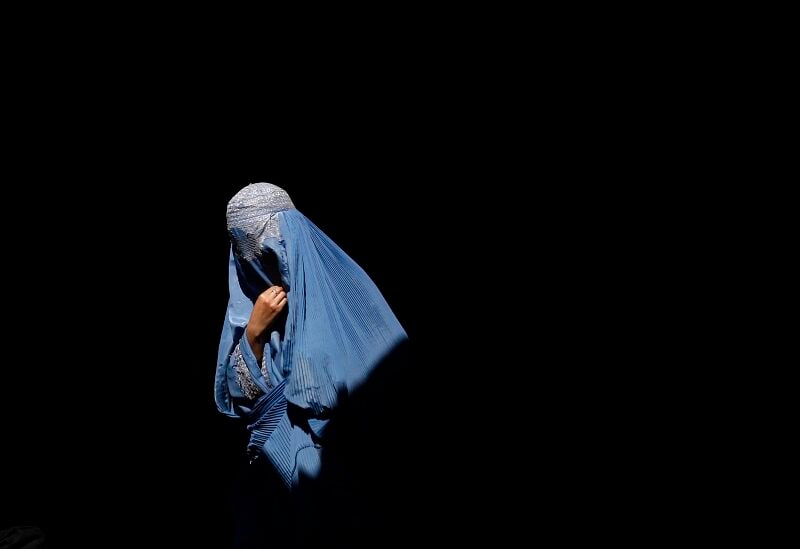 A burqa-clad Afghan woman walks in an old bazaar in Kabul March 4, 2009. Presidential polls in Afghanistan cannot be held next month as demanded by President Hamid Karzai, the elections commission said on Wednesday, with Aug. 20 to remain the polling day as originally scheduled. REUTERS/Ahmad Masood (AFGHANISTAN) - GM1E5341QY601