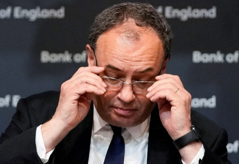 FILE PHOTO: Governor of the Bank of England Andrew Bailey adjusts his glasses as he addresses the media on the Monetary Policy Report at the Bank of England in London, Britain May 5, 2022. Frank Augstein/Pool via REUTERS/File Photo