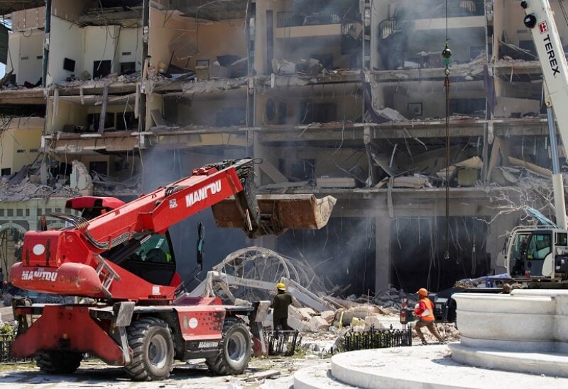 Rescue workers and firefighters work at the scene after an explosion hit the Hotel Saratoga, in Havana, Cuba May 6, 2022. REUTERS/Alexandre Meneghini
