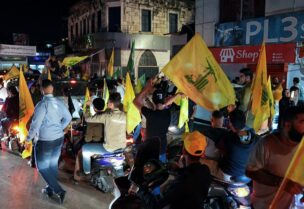 Supporters of Lebanon's Hezbollah leader Sayyed Hassan Nasrallah and Amal Movement carry flags while riding in a convoy as votes are being counted in Lebanon's parliamentary election, in Nabatiyeh, southern Lebanon May 15, 2022. REUTERS/Issam Abdallah
