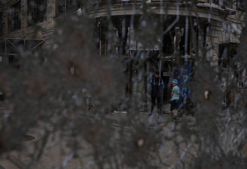 Kids stands by a damaged building after Russian shelling at a residential area, amid Russia's invasion of Ukraine, in Irpin, Ukraine May 7, 2022. REUTERS/Carlos Barria