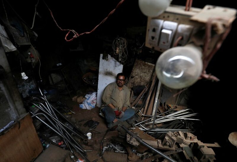 Zahiruddin, 42, a metal-welder pauses during power outages and hot weather, at workshop in Karachi, Pakistan May 12, 2022. REUTERS/Akhtar Soomro