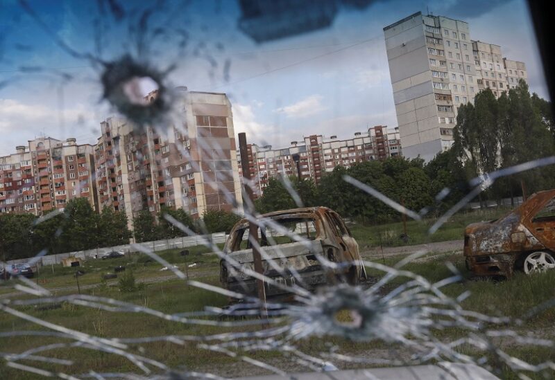 Burnt cars are pictured through the glass of a damaged car in Saltivka neighbourhood, amid Russia's attack on Ukraine, in Kharkiv, Ukraine, May 10, 2022. REUTERS/Ricardo Moraes