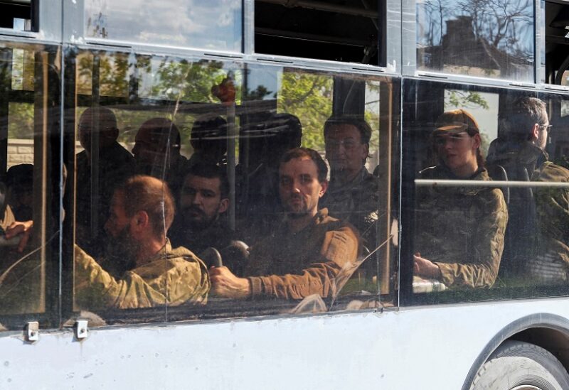 A bus carrying service members of the Ukrainian armed forces, who surrendered at the besieged Azovstal steel mill, drives away under escort of the pro-Russian military in the course of the Ukraine-Russia conflict, in Mariupol, Ukraine May 20, 2022. REUTERS/Alexander Ermochenko TPX IMAGES OF THE DAY