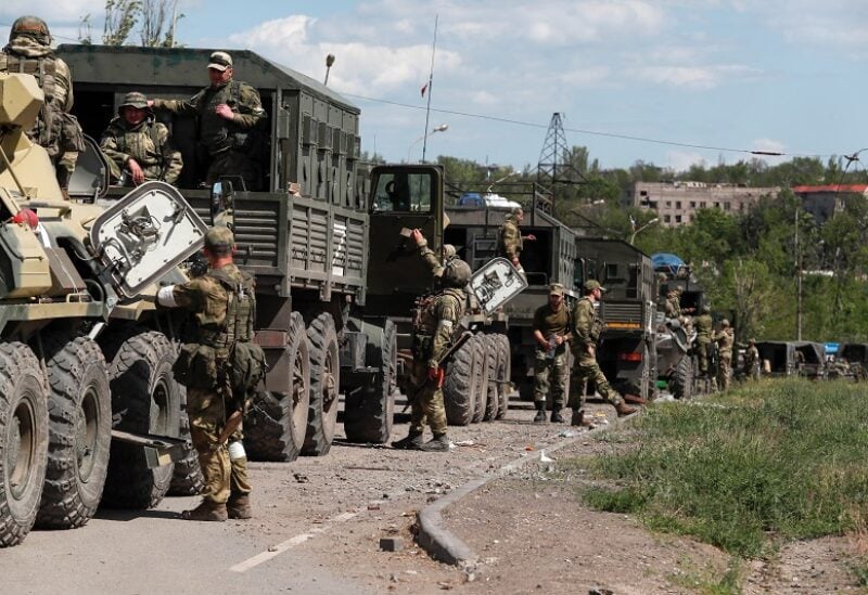 A convoy of pro-Russian troops is seen before the expected evacuation of wounded Ukrainian soldiers from the besieged Azovstal steel mill in the course of Ukraine-Russia conflict in Mariupol, Ukraine May 16, 2022. REUTERS/Alexander Ermochenko