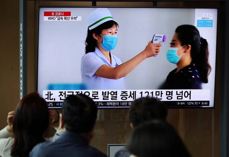 People watch a TV broadcasting a news report on the coronavirus disease (COVID-19) outbreak in North Korea, at a railway station in Seoul, South Korea, May 17, 2022. REUTERS/Kim Hong-Ji