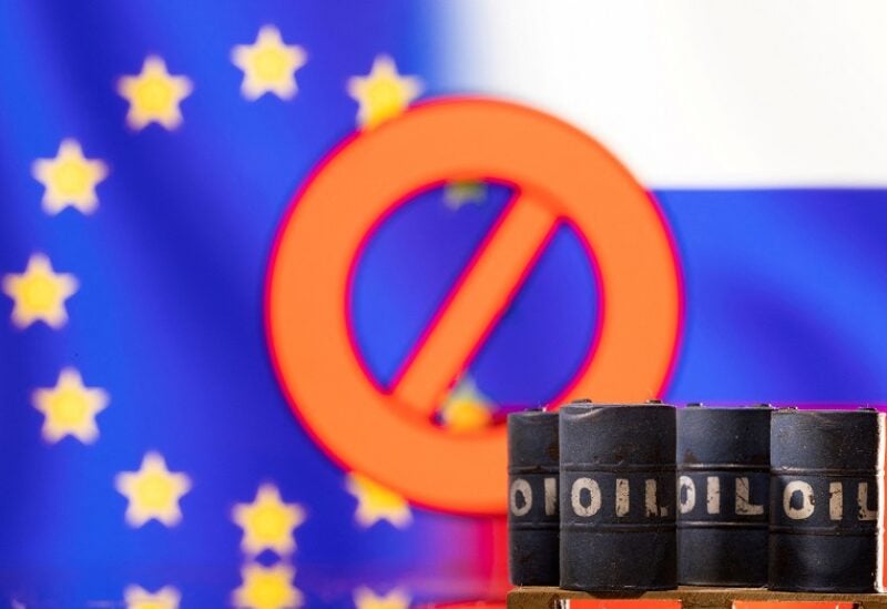 FILE PHOTO: Models of oil barrels are seen in front of the displayed sign "stop", EU and Russia flag colours in this illustration taken March 8, 2022. REUTERS/Dado Ruvic/Illustration/File Photo