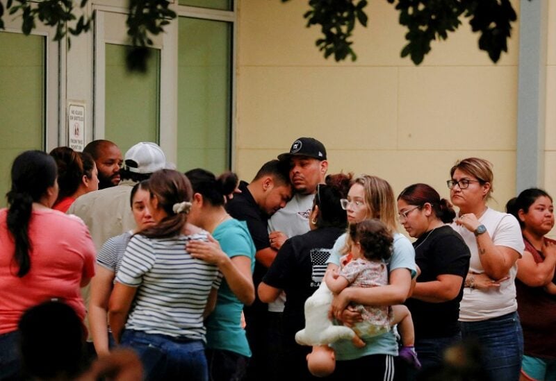 People react outside the Ssgt Willie de Leon Civic Center, where students had been transported from Robb Elementary School after a shooting, in Uvalde, Texas, U.S. May 24, 2022. REUTERS/Marco Bello REFILE - QUALITY REPEAT