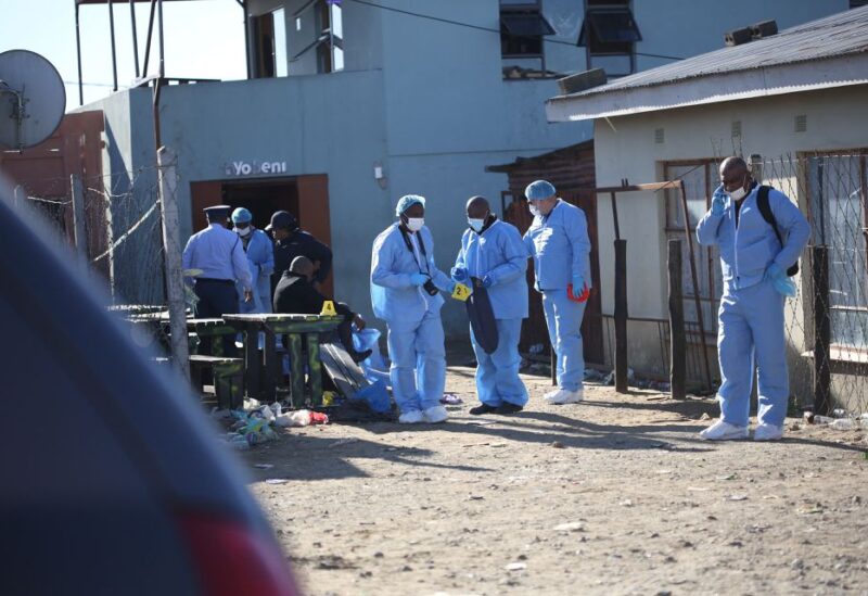 Forensic personnel investigate after the deaths of patrons found inside the Enyobeni Tavern, in Scenery Park, outside East London in the Eastern Cape province, South Africa, June 26, 2022. REUTERS/Stringer