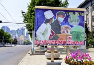 A sign depicting a scene of medical products transportation is displayed at the empty street, amid growing fears over the spread of coronavirus disease (COVID-19), in Pyongyang, North Korea, in this photo released by Kyodo on May 23, 2022. Kyodo via REUTERS